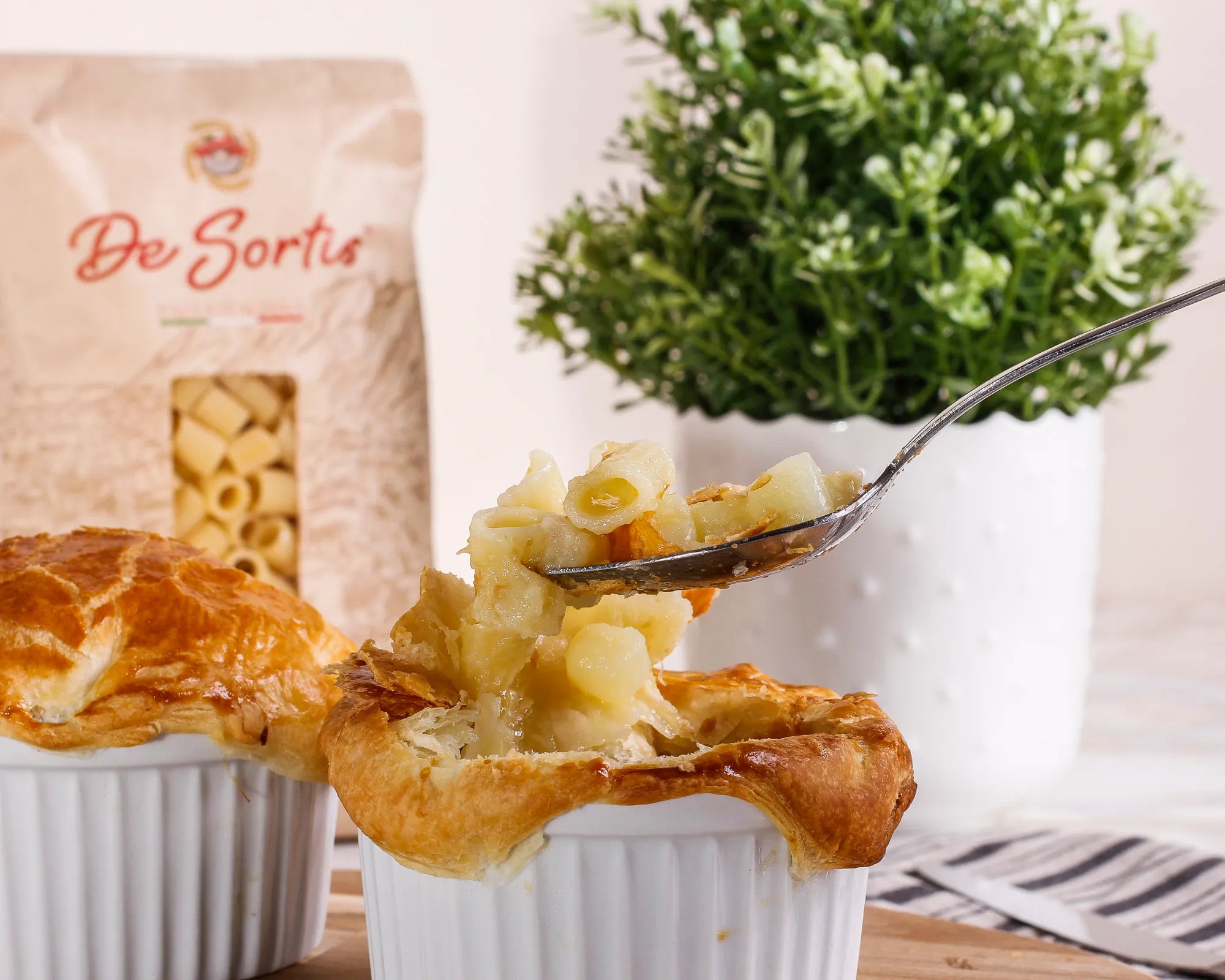 Pasta and potato cocotte with melted provola cheese and a crispy puff pastry shell 