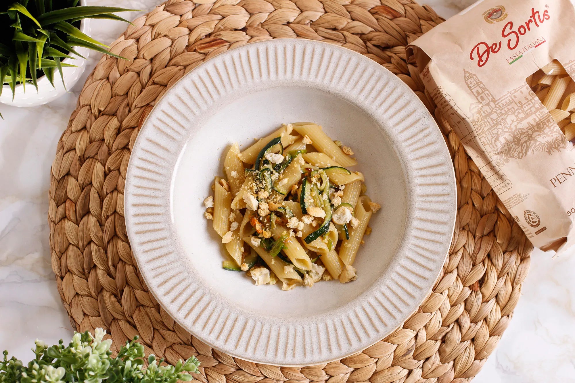Penne with courgettes and courgette flowers with Apulian tarallini 