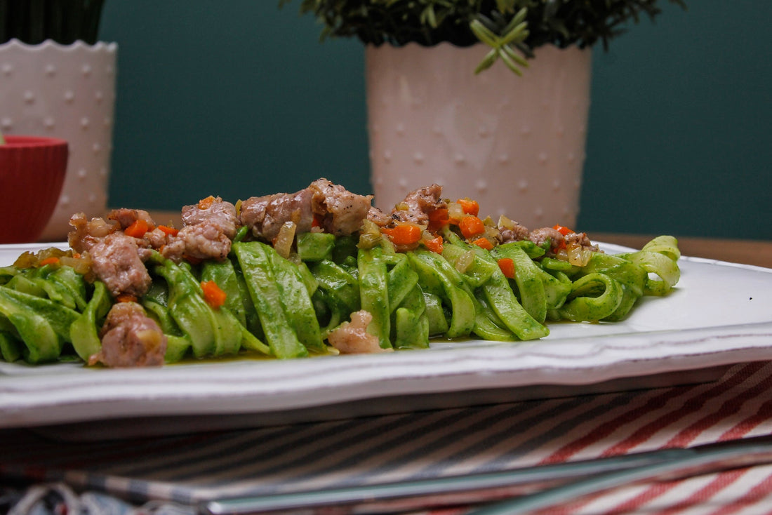 Tagliatelle mantecate in crema di cime di rapa con ragù bianco di salsiccia al malvasia