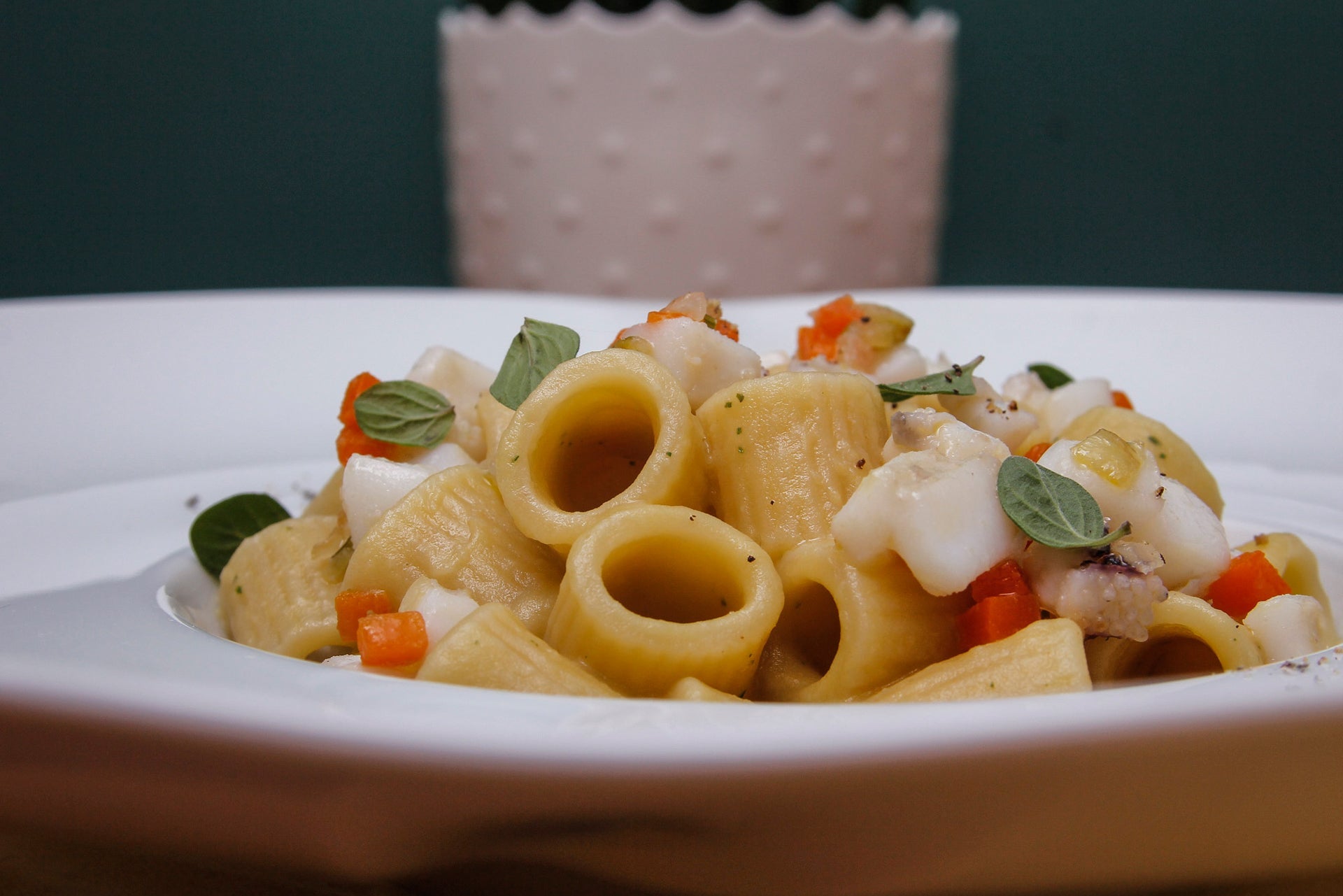 Mezze maniche pasta tossed in chickpea cream with fresh oregano and a knife-cut cuttlefish and lemon ragù 