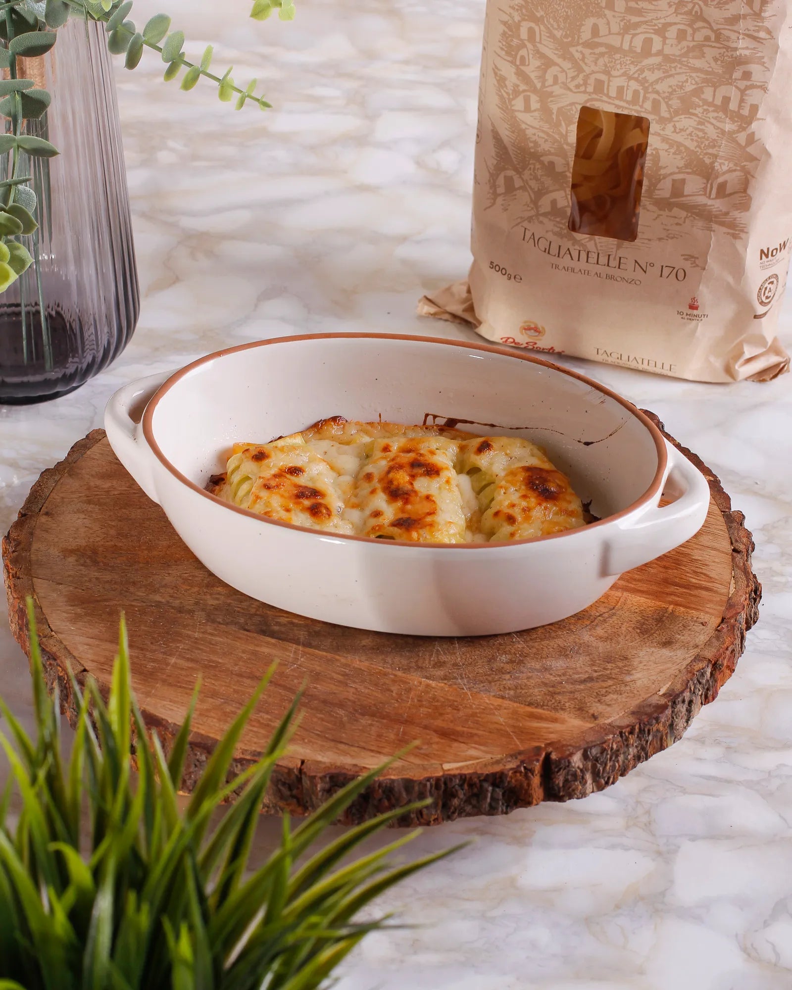 Tagliatelle balls stuffed with ricotta and spinach, baked in the oven with béchamel sauce and parmesan cheese 