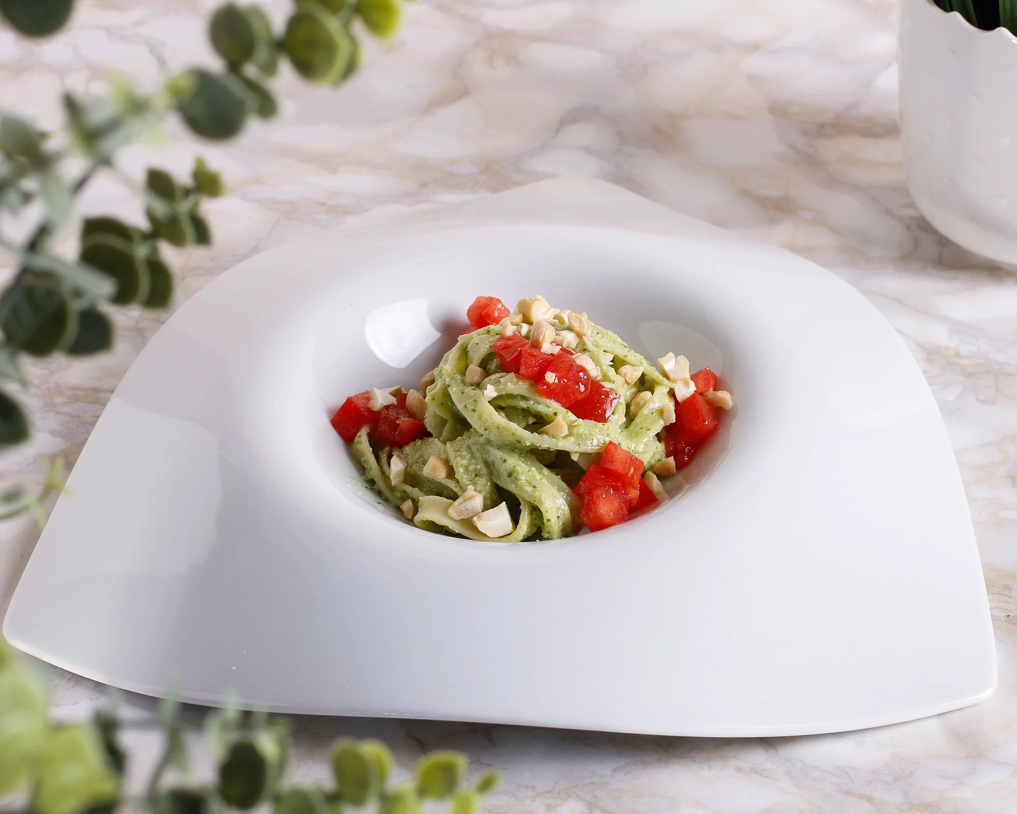 Tagliatelle with arugula and cashew pesto, marinated tomato cubes, and crunchy cashews. 