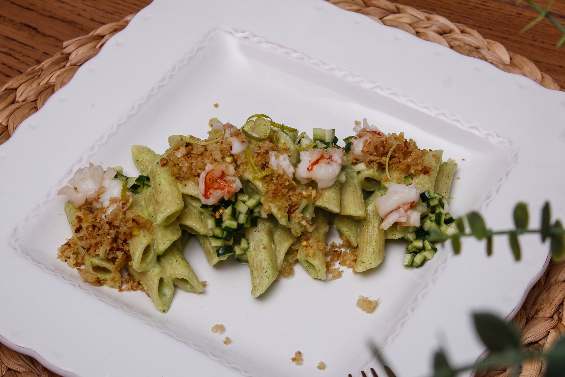 Penne pasta in creamed zucchini with raw zucchini tartare and lemon, seared prawns and crunchy pistachio bread. 